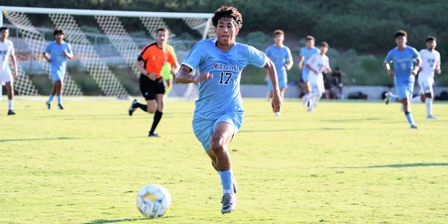 Alonso from Men's Soccer takes the ball down the field to score.