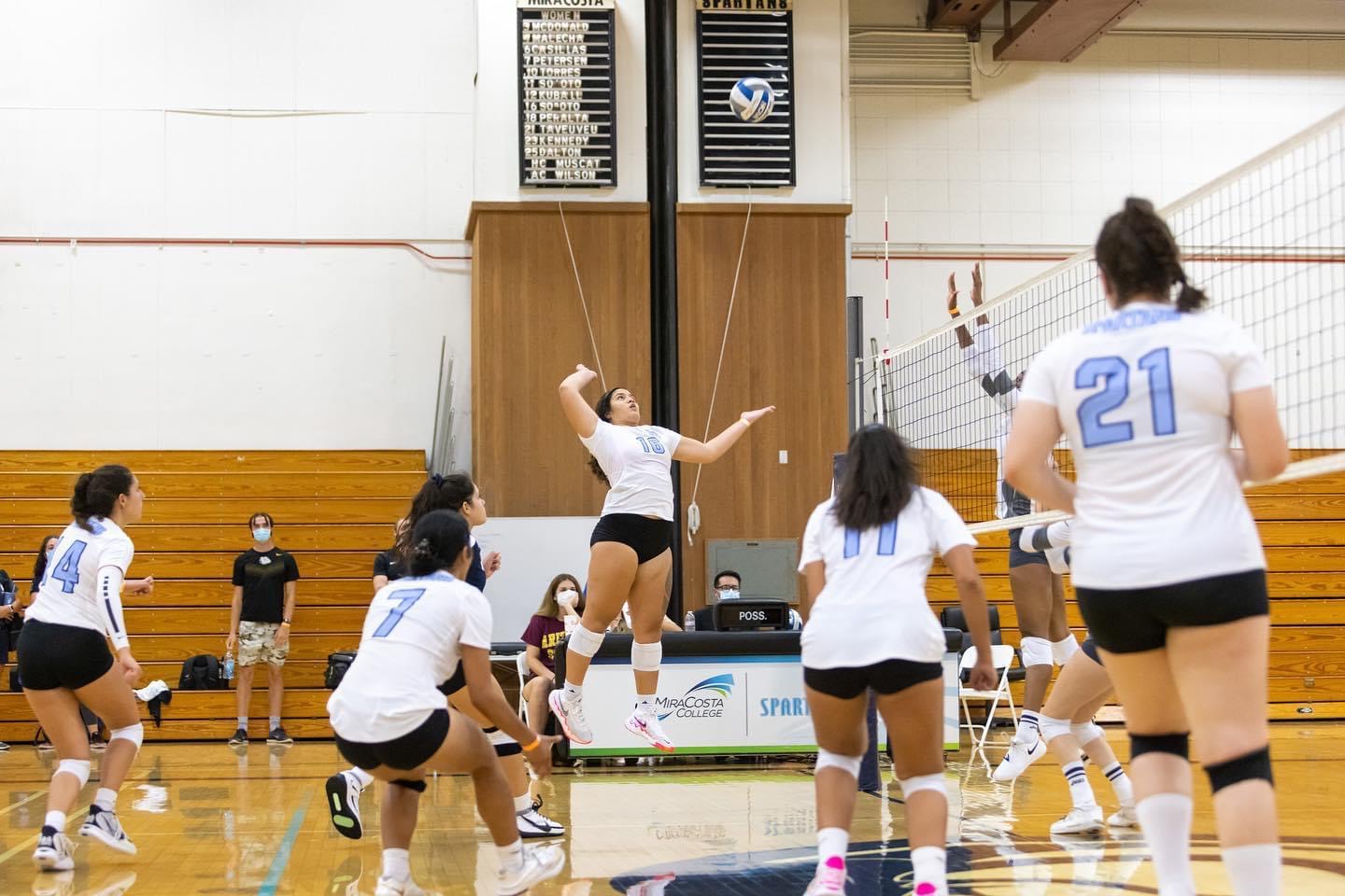 Sophomore Savannah So'oto jumps to hit a volleyball.