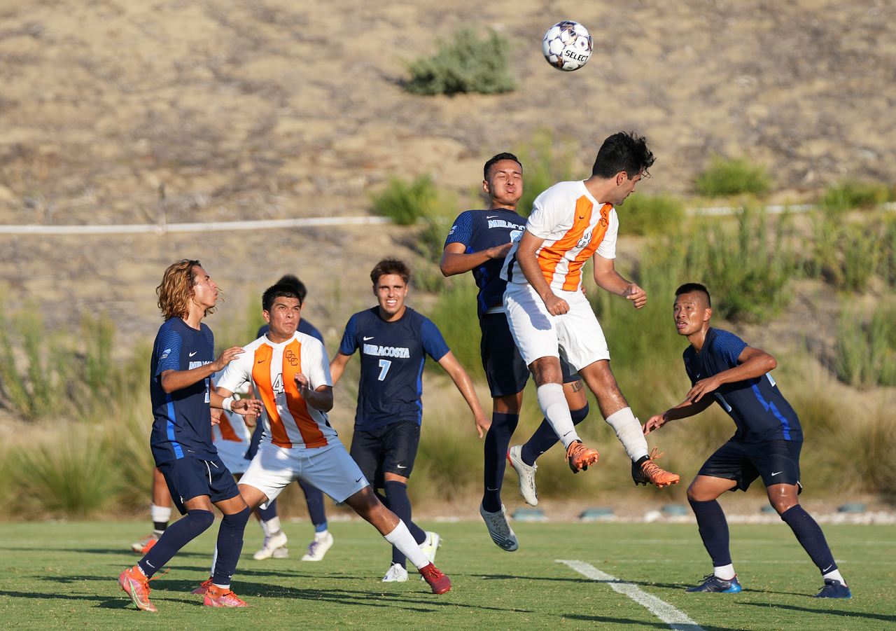 MiraCosta player jumps in the air for a header in the soccer game.