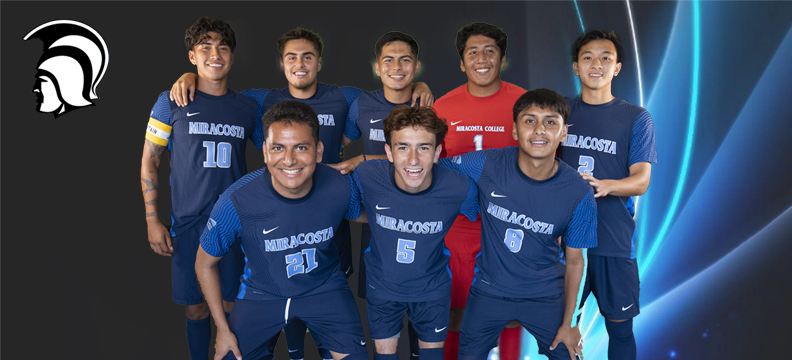 Men's soccer team poses for a picture.