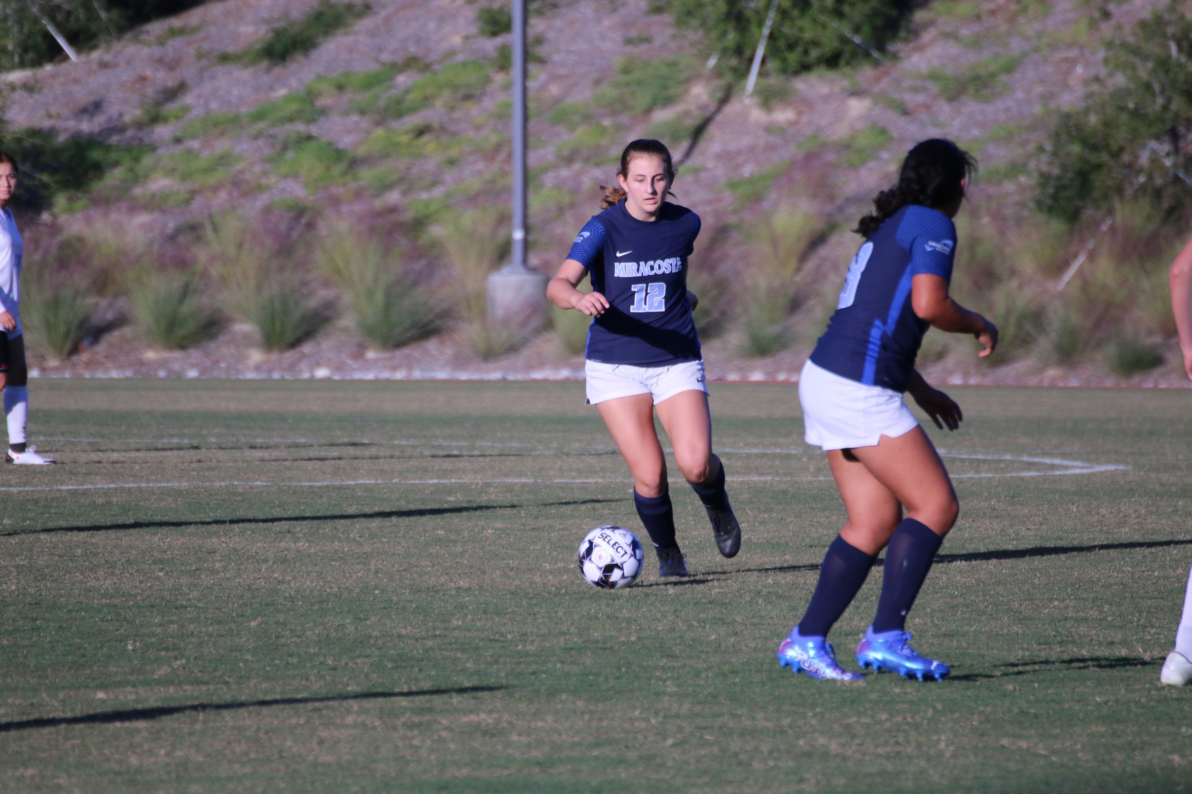 Katy King dribbles the soccer ball during a game.